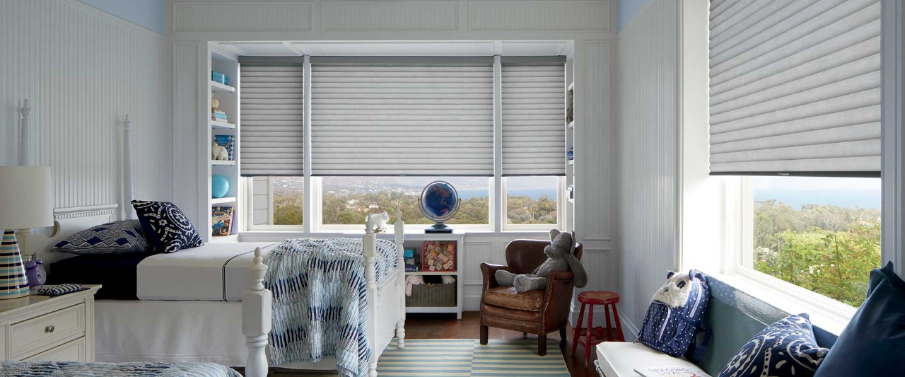 Kids beroom with navy blue accents and Sonnette roller shades.